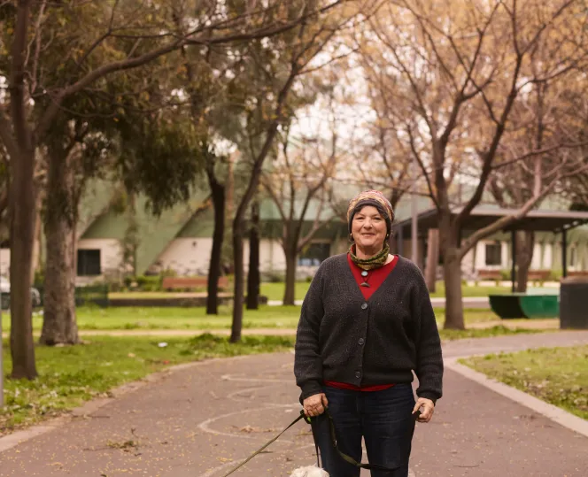 Person holding 2 dogs on a lead