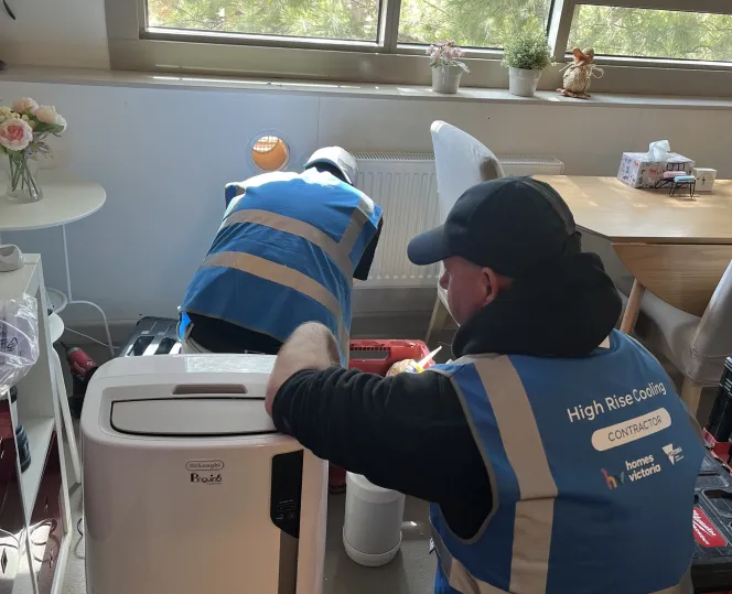 two people installing a portable aircon