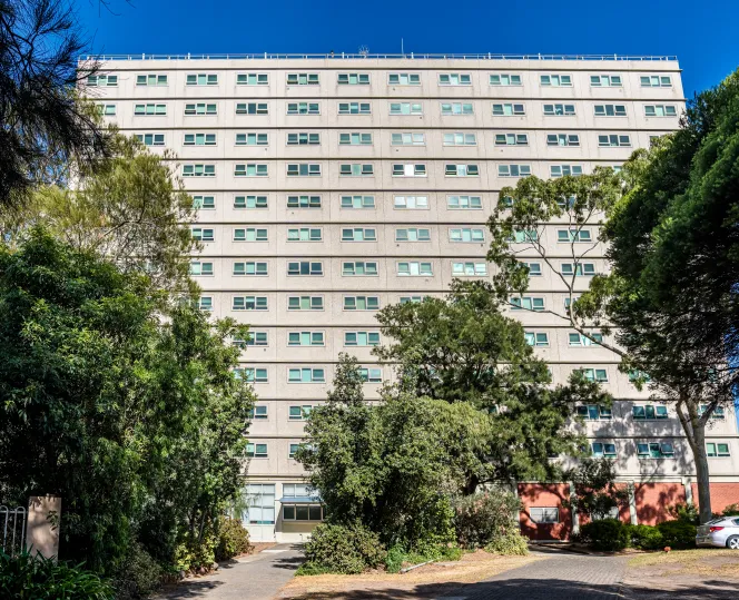 Apartment building with trees in front of it