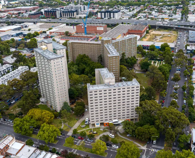 Aerial photo of 3 apartment towers surrounded by other buildings