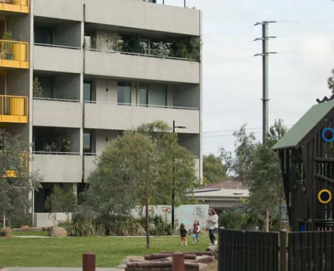 Image of park and play equipment in front of apartments