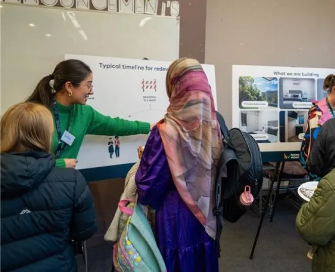 Image of staff and community at the information centre attending the session to find more about the project