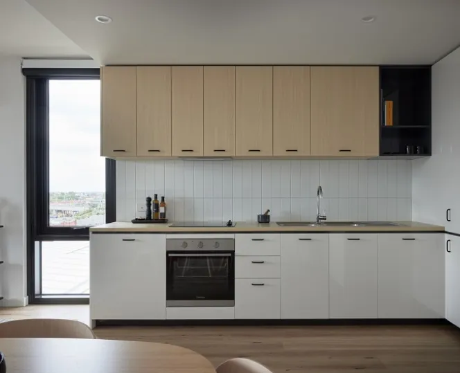Image of modular kitchen with cabinets above and below the bench top along with electric cooktop and oven installed 