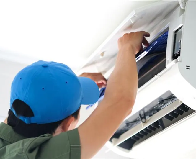 Image of man fixing air con