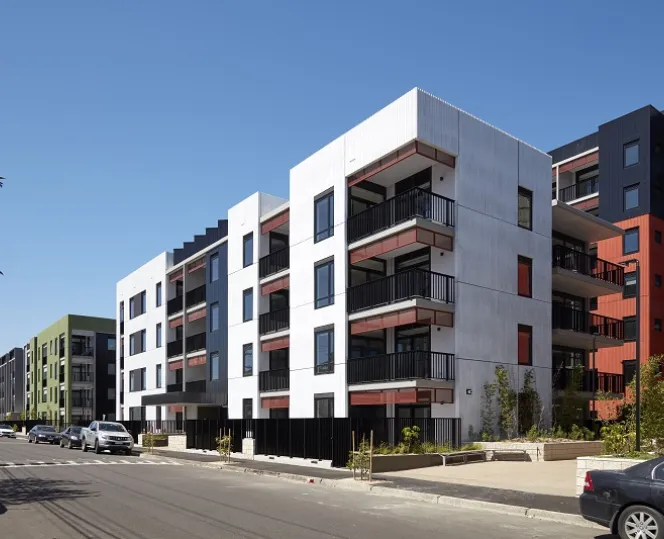 Image of Affordable housing tall apartments with windows and balcony facing towards the street