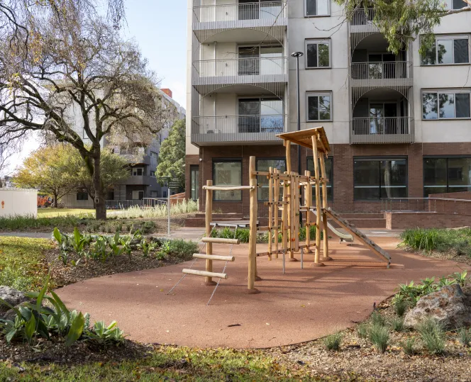 Image of  modern apartment set amid open green spaces and lush landscaped gardens with children's play area