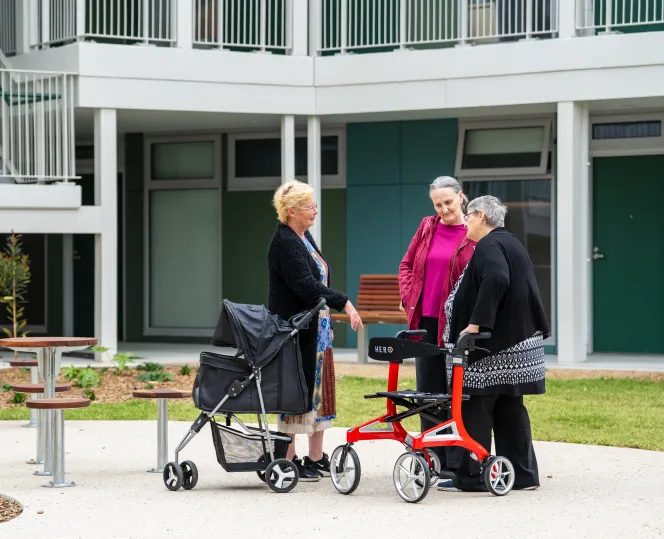 Image of summerhill community members standing together and having a conversation