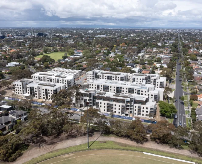 Aerial view of the Bluff Road Hampton East apartment surrounded by trees and nearby residential streets