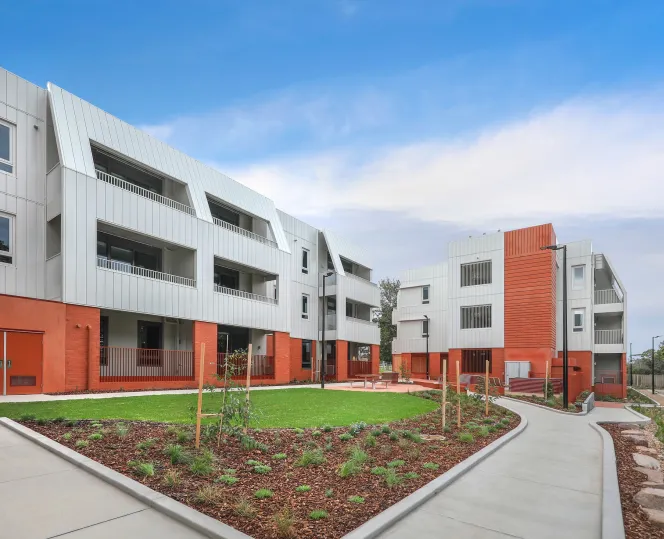Image of apartment building with balconies and windows, with a beautiful landscaping
