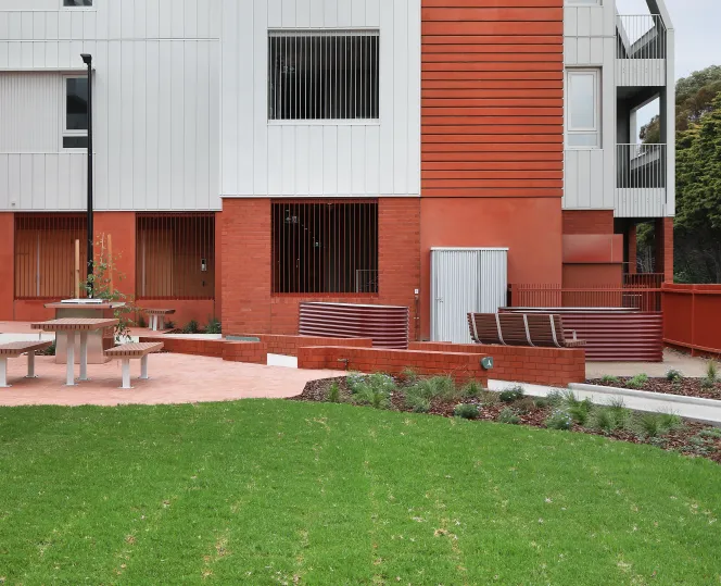 Image of apartment building with windows, with a beautiful landscaping