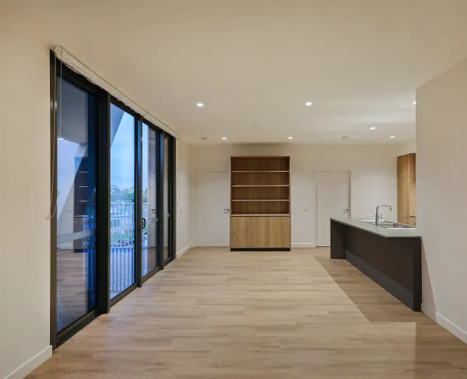 Interior of apartment featuring the hall way attached with the kitchen and big glass door for balcony