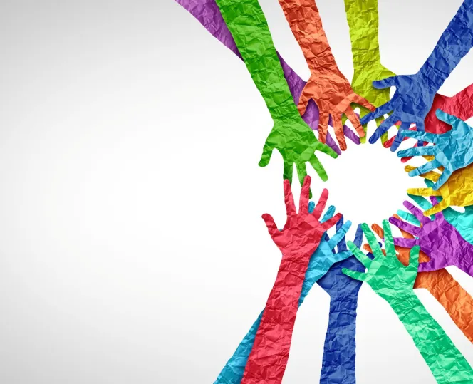 Colourful paper hands in a circle supporting each other