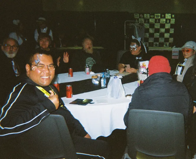 Group of people sitting around a table - some in fancy dress