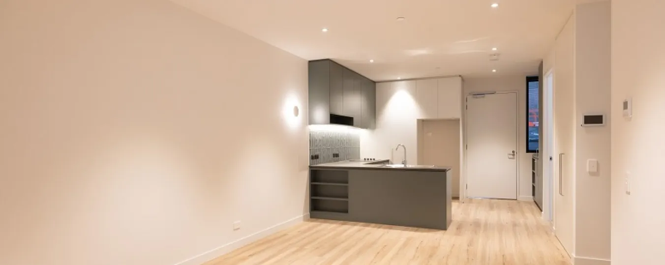 Image of wide drawing room with modern kitchen attached