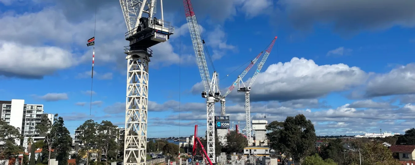 3 tower cranes on a construction site