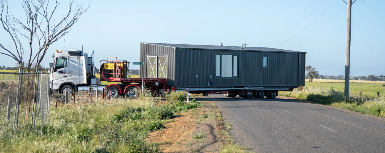 A truck with a modular home on the trailor