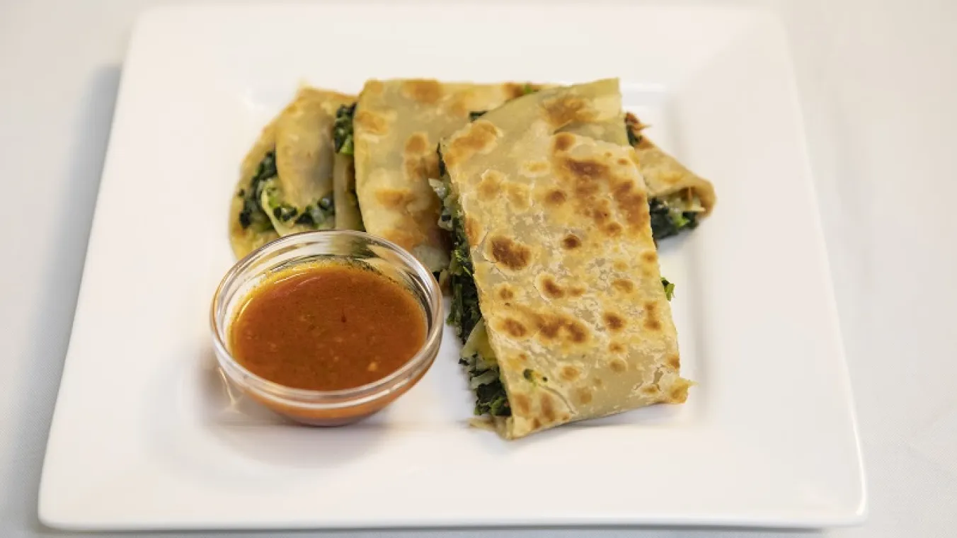 Iage of Fatuma's Spinach chapati with sauce on a plate