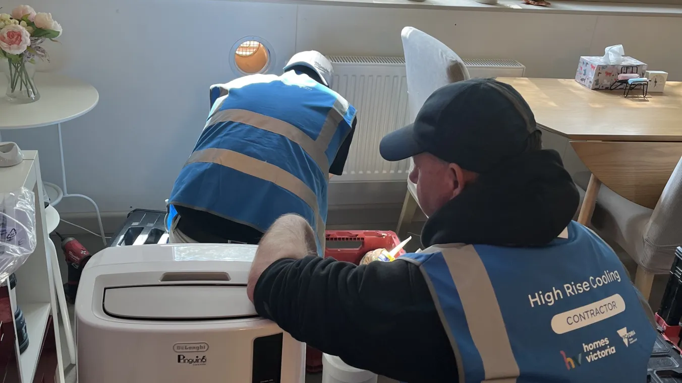 two people installing a portable aircon