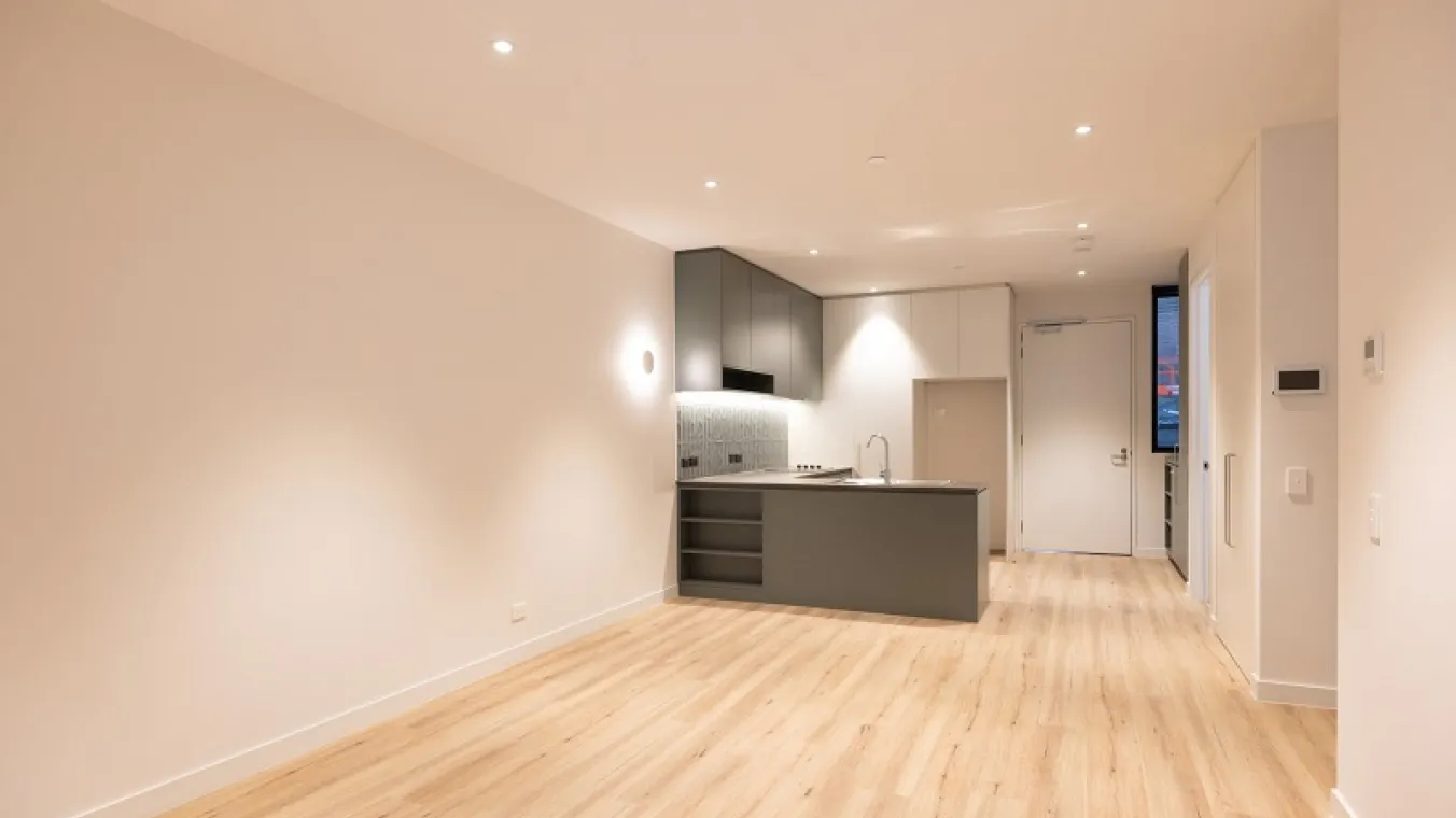 Image of wide drawing room with modern kitchen attached