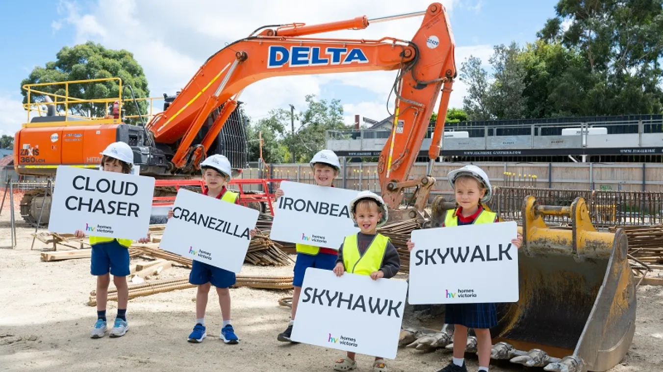 Image of 5 kinds holding banners in front of crane
