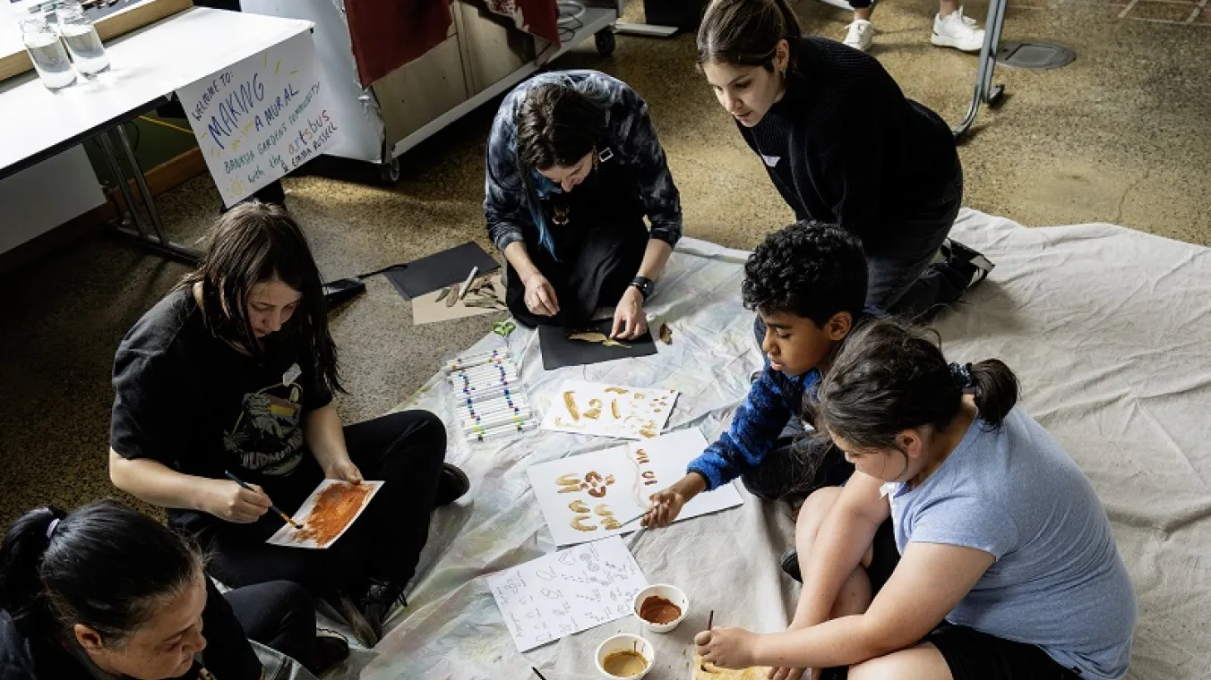 Artists for Kids Culture helping students with their designs, pictured here in Banksia Gardens Arts Workshop