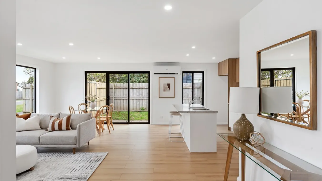 Image of living area attached with kitchen and meal area having sliding door for the backyard