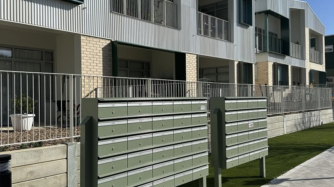 Image of apartment at Summerhill Village with letter box for every unit outside the building