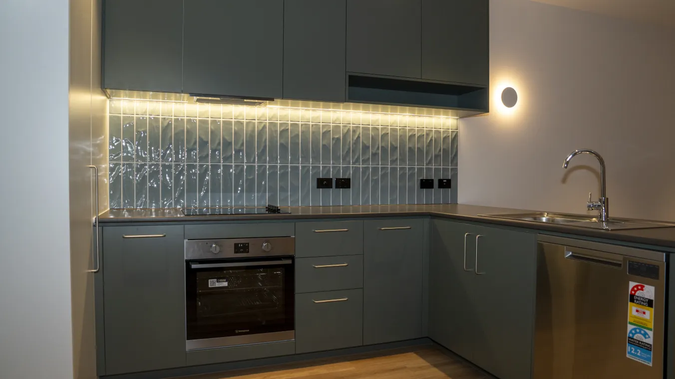 Image of  modern apartment  with moulder kitchen, dishwasher, electric cook top, and oven 
