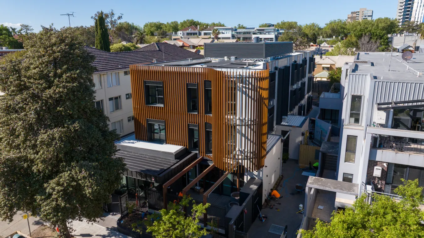 Image of a tall building on Madden House St Kilda, and nearby houses
