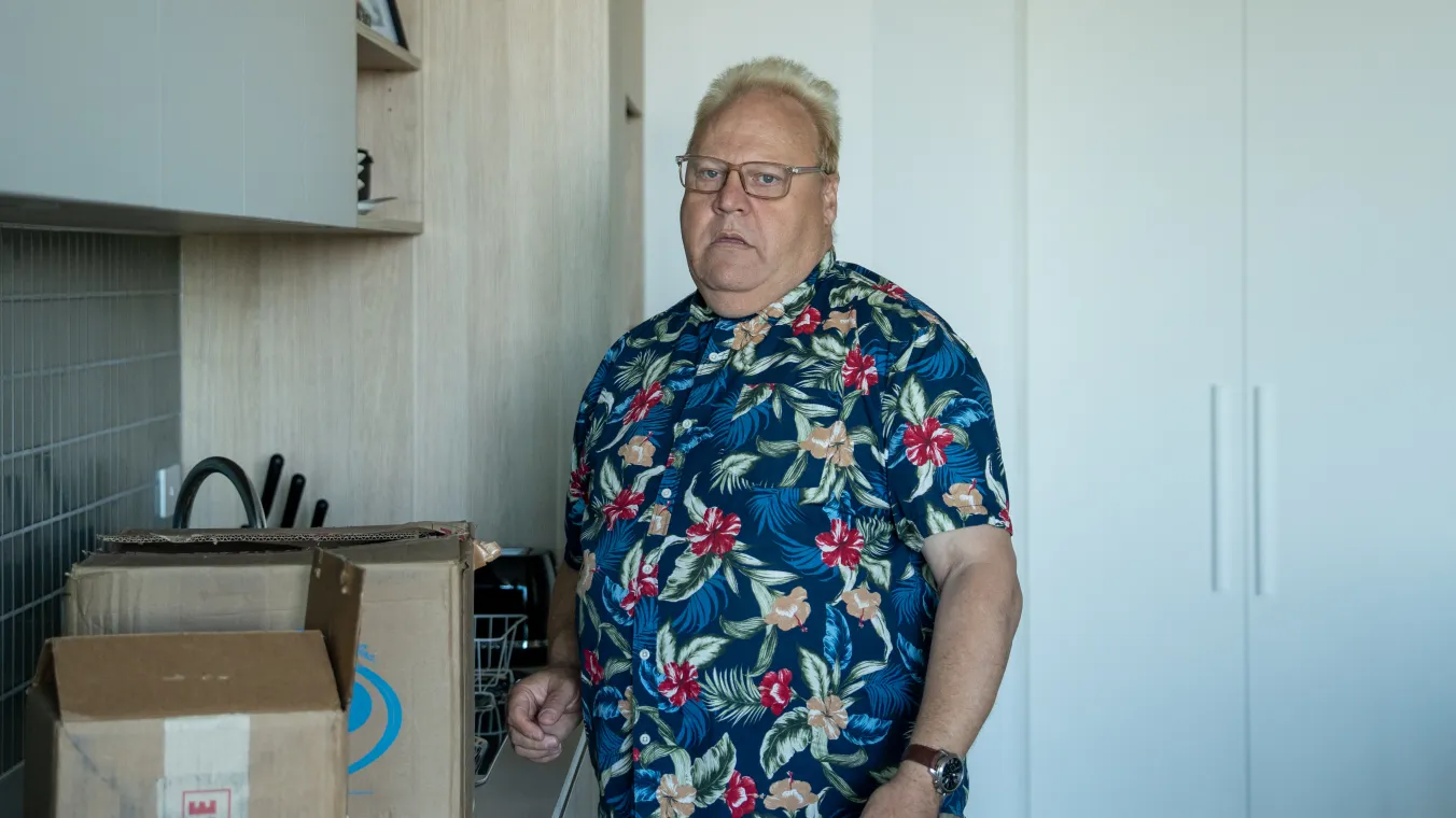 Image of a man standing next to the boxes