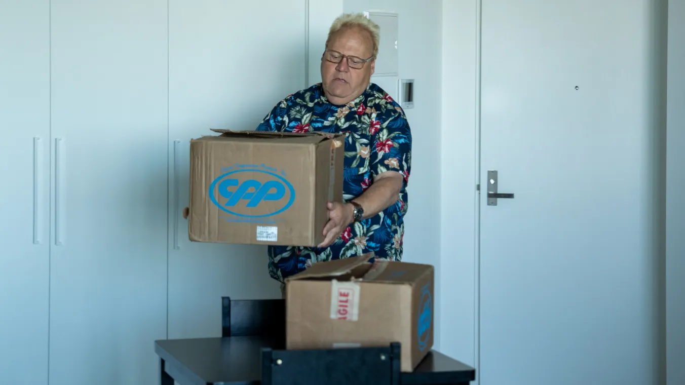 Image of a man moving boxes 