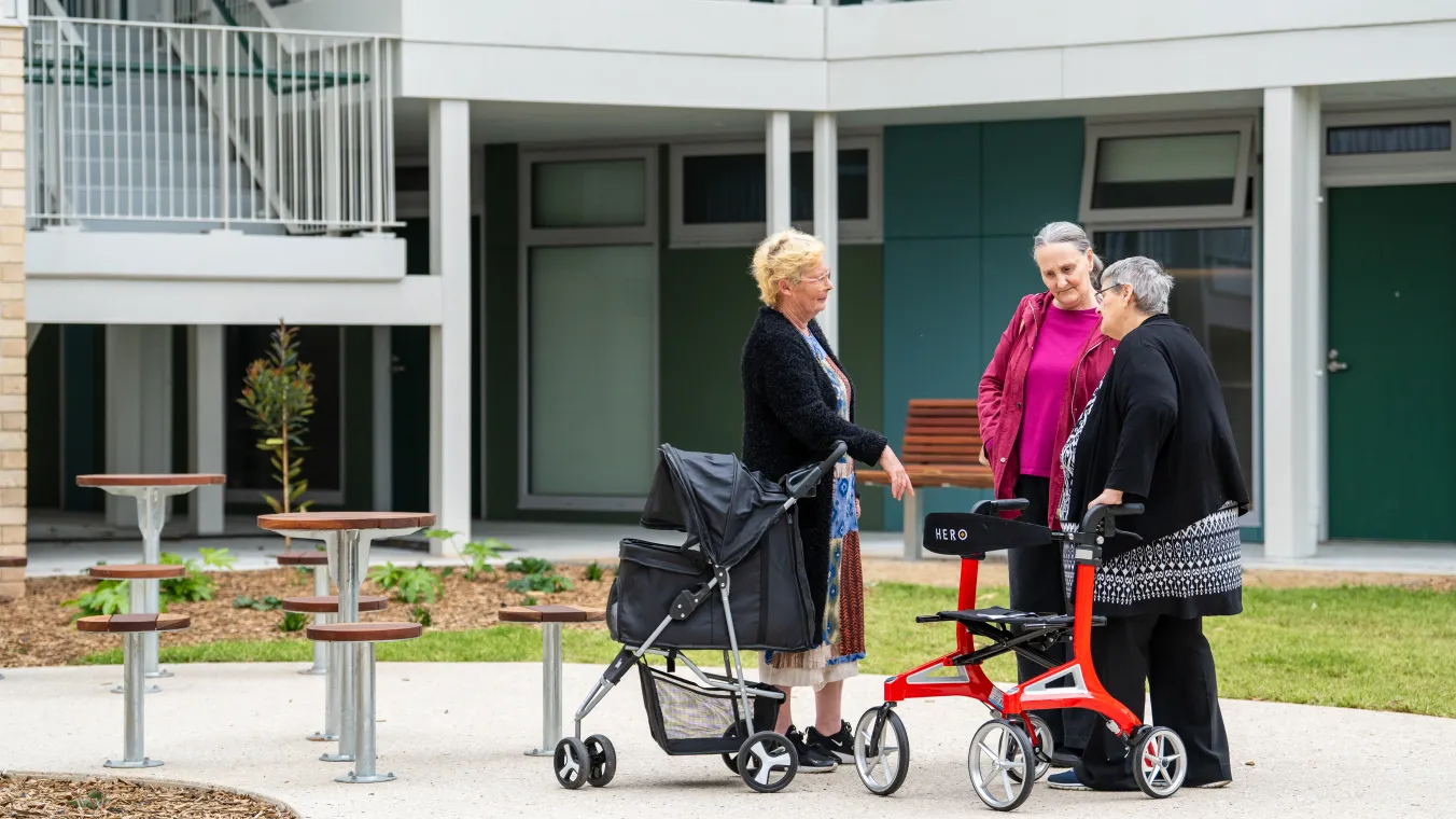 Image of summerhill community members standing together and having a conversation