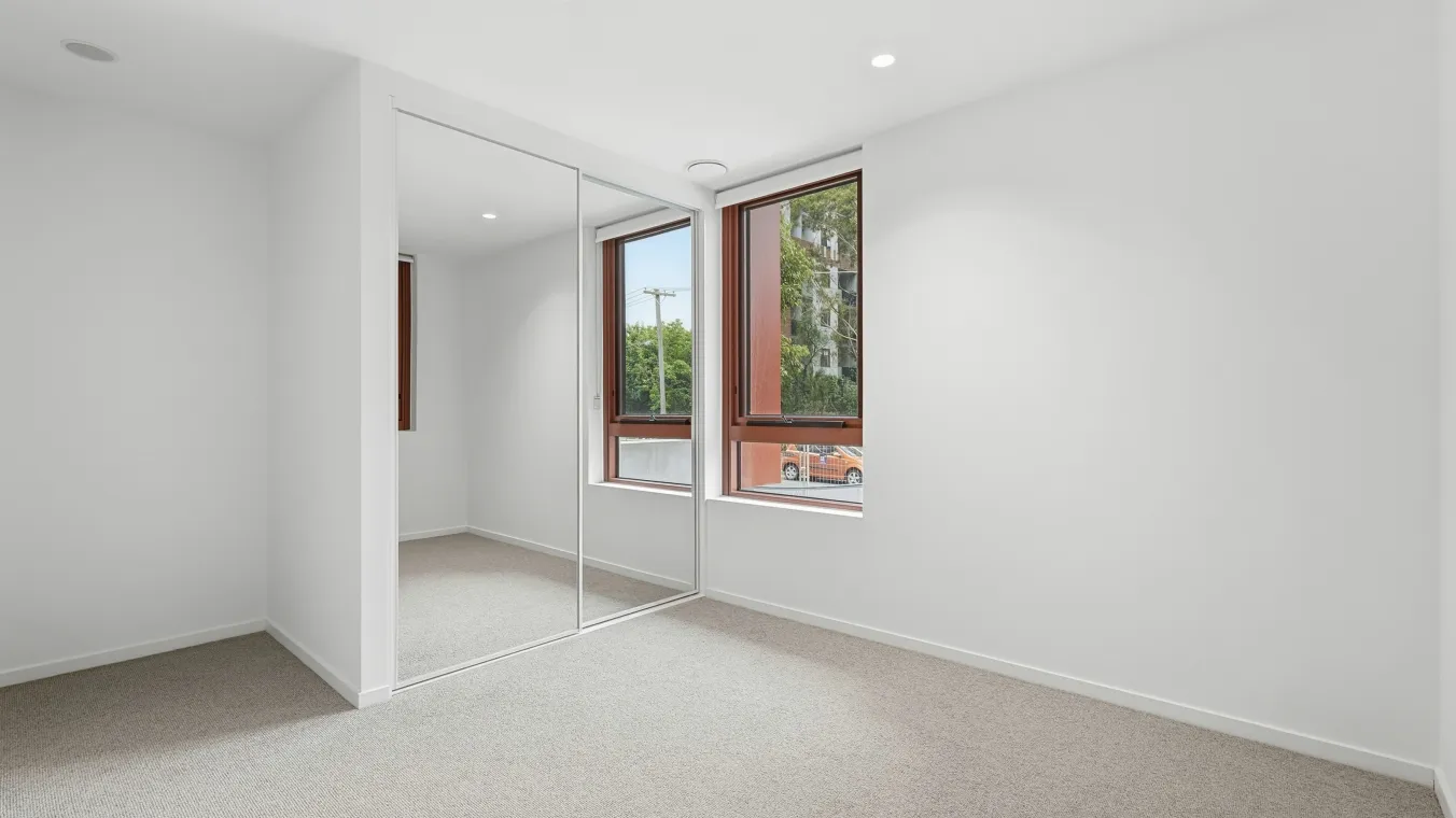 Image of Inside a bedroom with a window and a mirrored wardrobe 