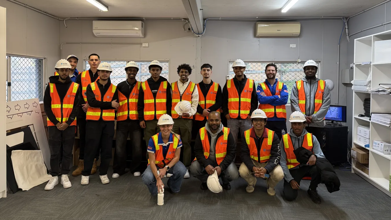 People standing together wearing safety vests and helmets on work place