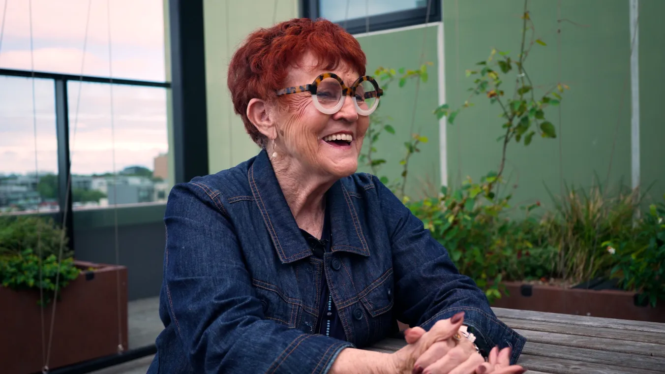 Image of lady laughing while have conversation