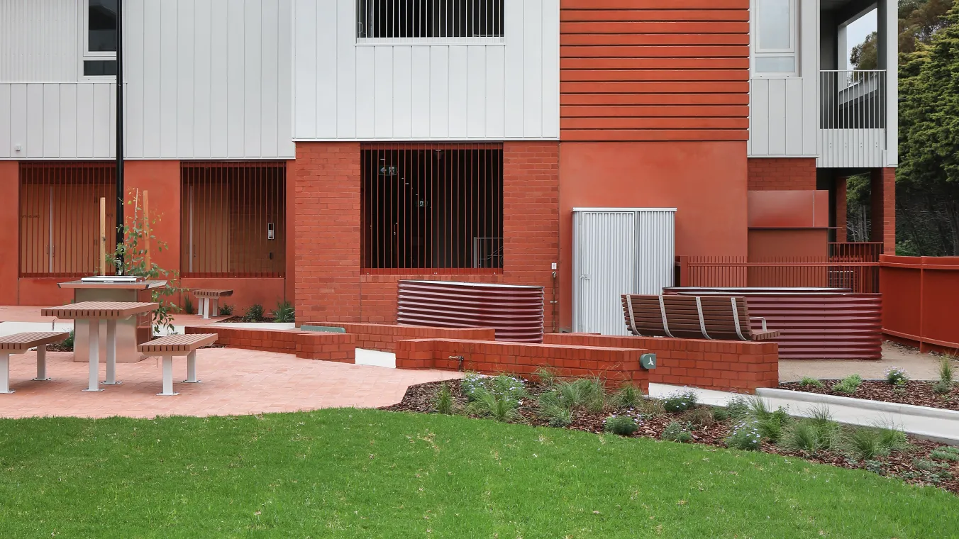 Image of apartment building with windows, with a beautiful landscaping
