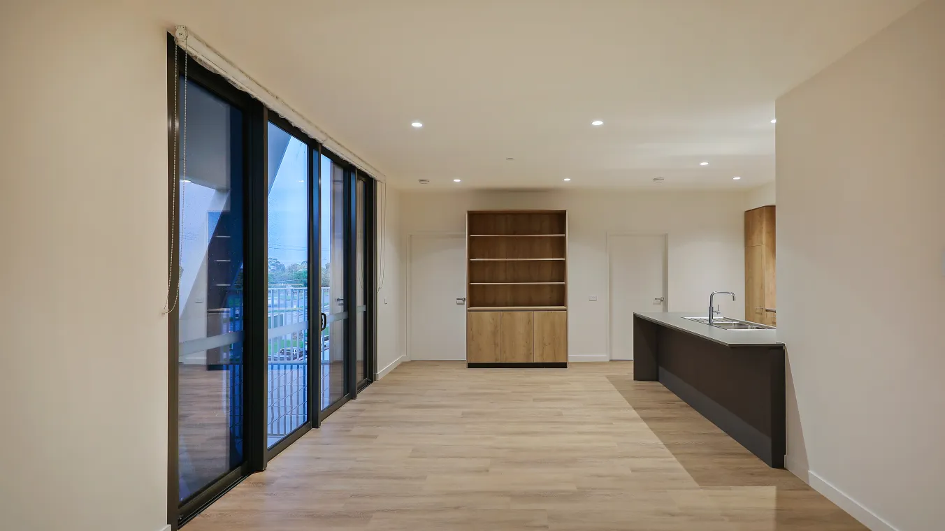 Interior of apartment featuring the hall way attached with the kitchen and big glass door for balcony