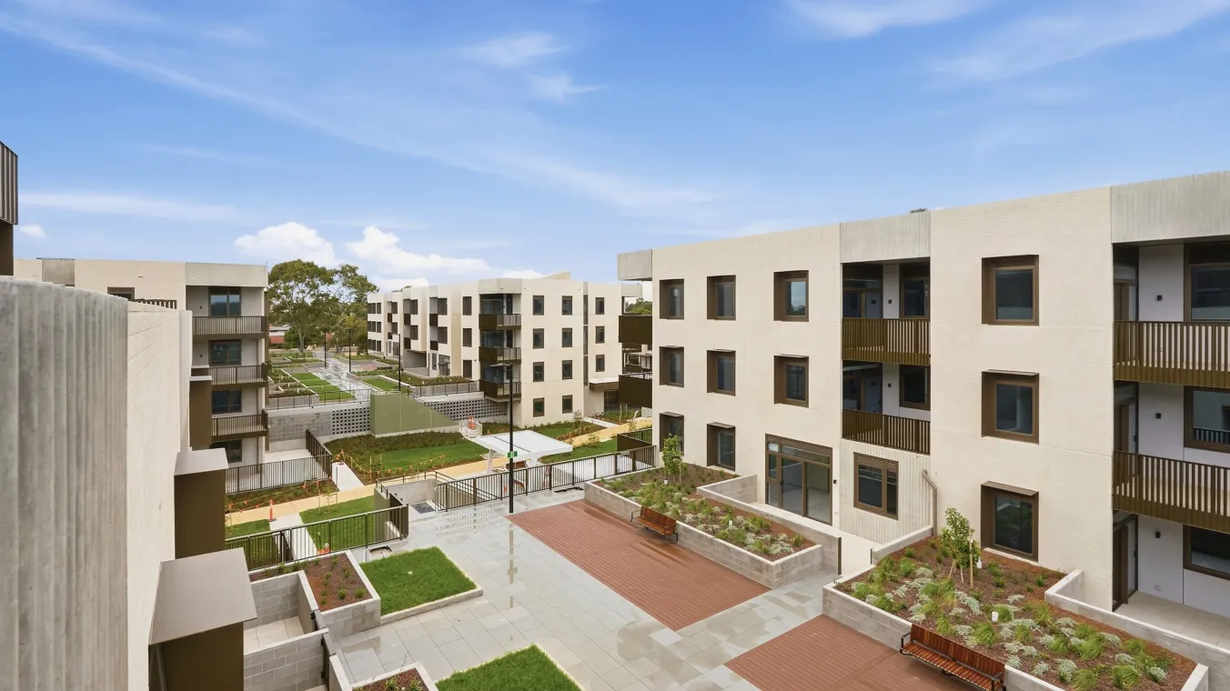 Outdoor shared podium with lawns, benches, and small plant planted