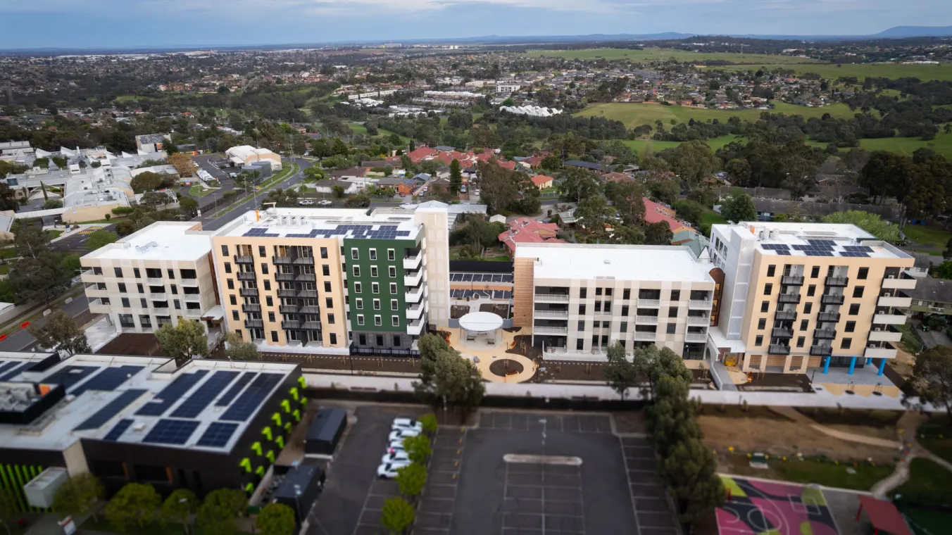 New residential buildings with ample parking, rooftop solar panels and a children’s play area.  